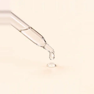 Argireline: a clear drop at the tip of a glass pipette
