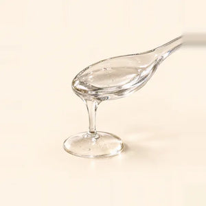 Glycerin: thick, clear liquid in a glass spoon
