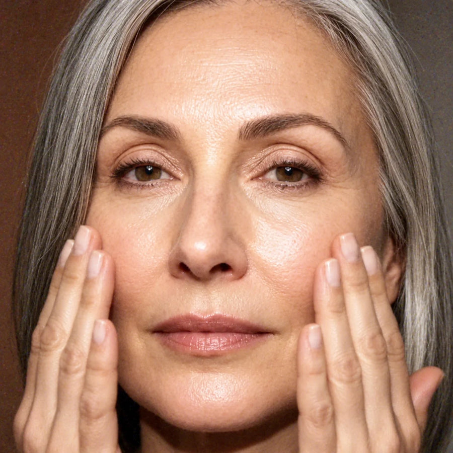 A woman over 40 with her hands on her cheeks