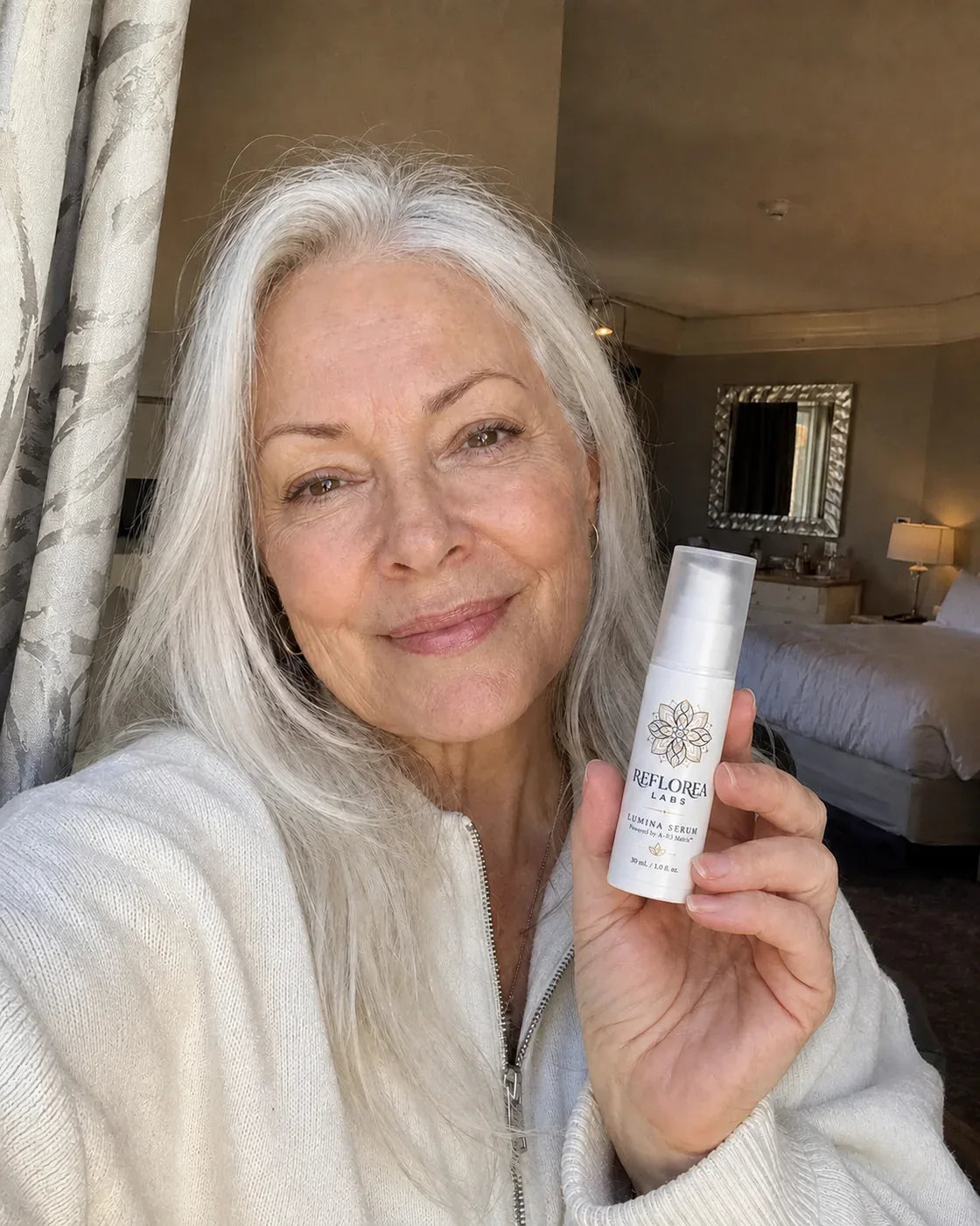 Woman holding the Lumina Serum bottle
