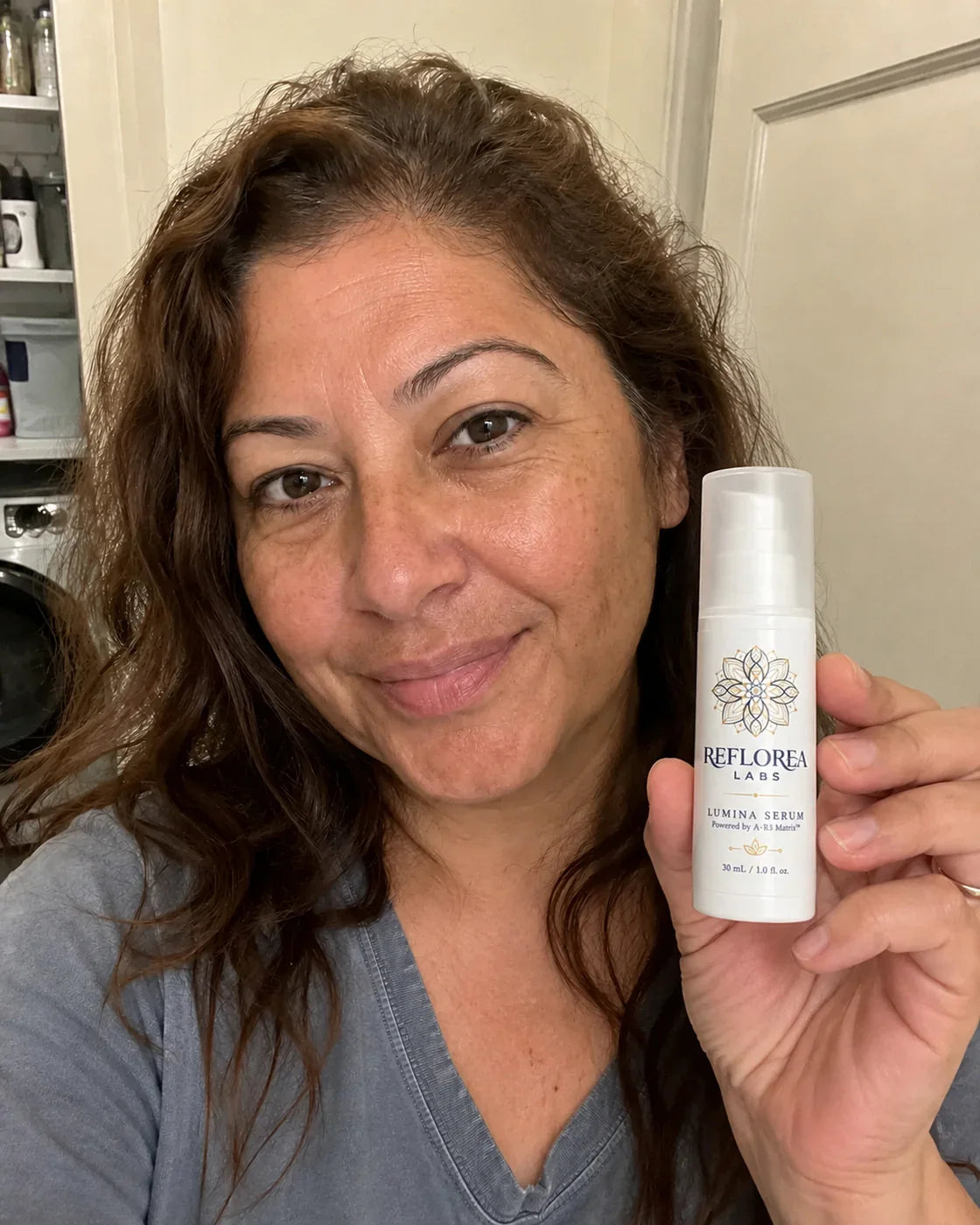 Woman holding the Lumina Serum bottle