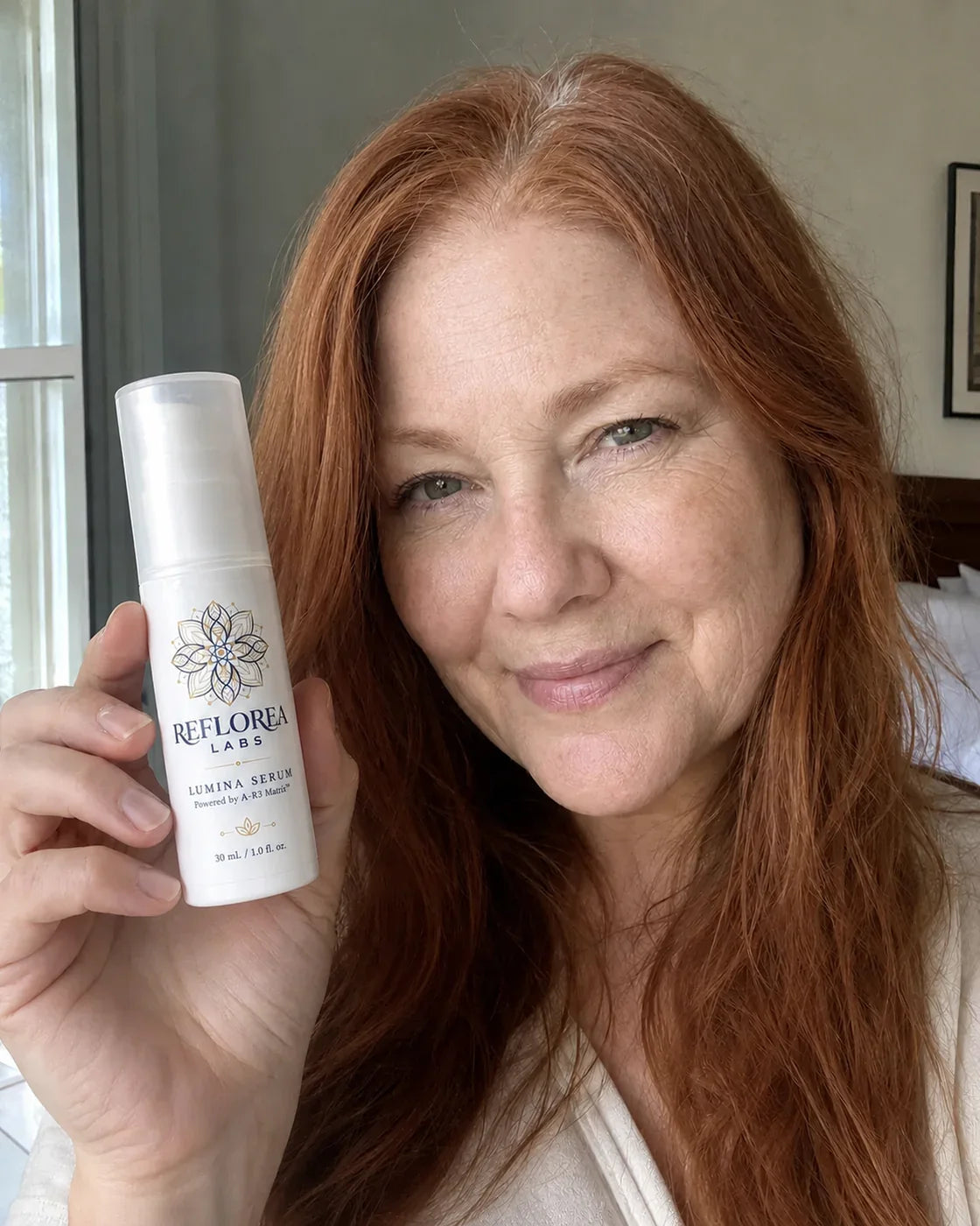 Woman holding the Lumina Serum bottle