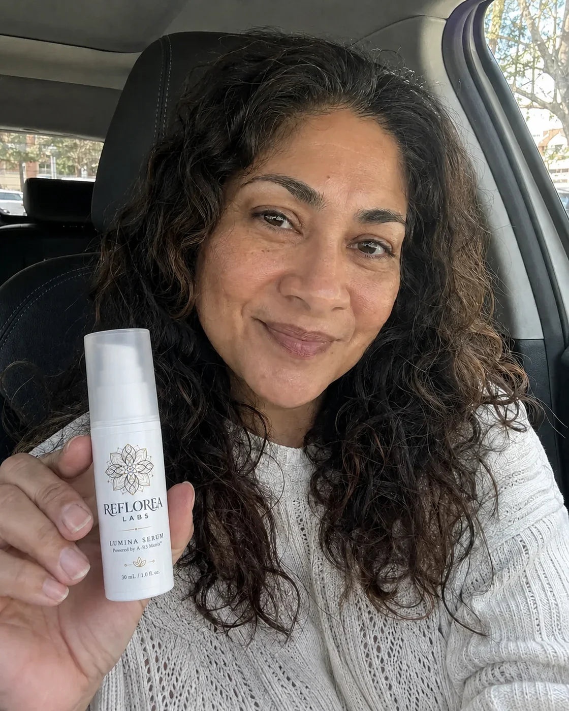 Woman holding the Lumina Serum bottle
