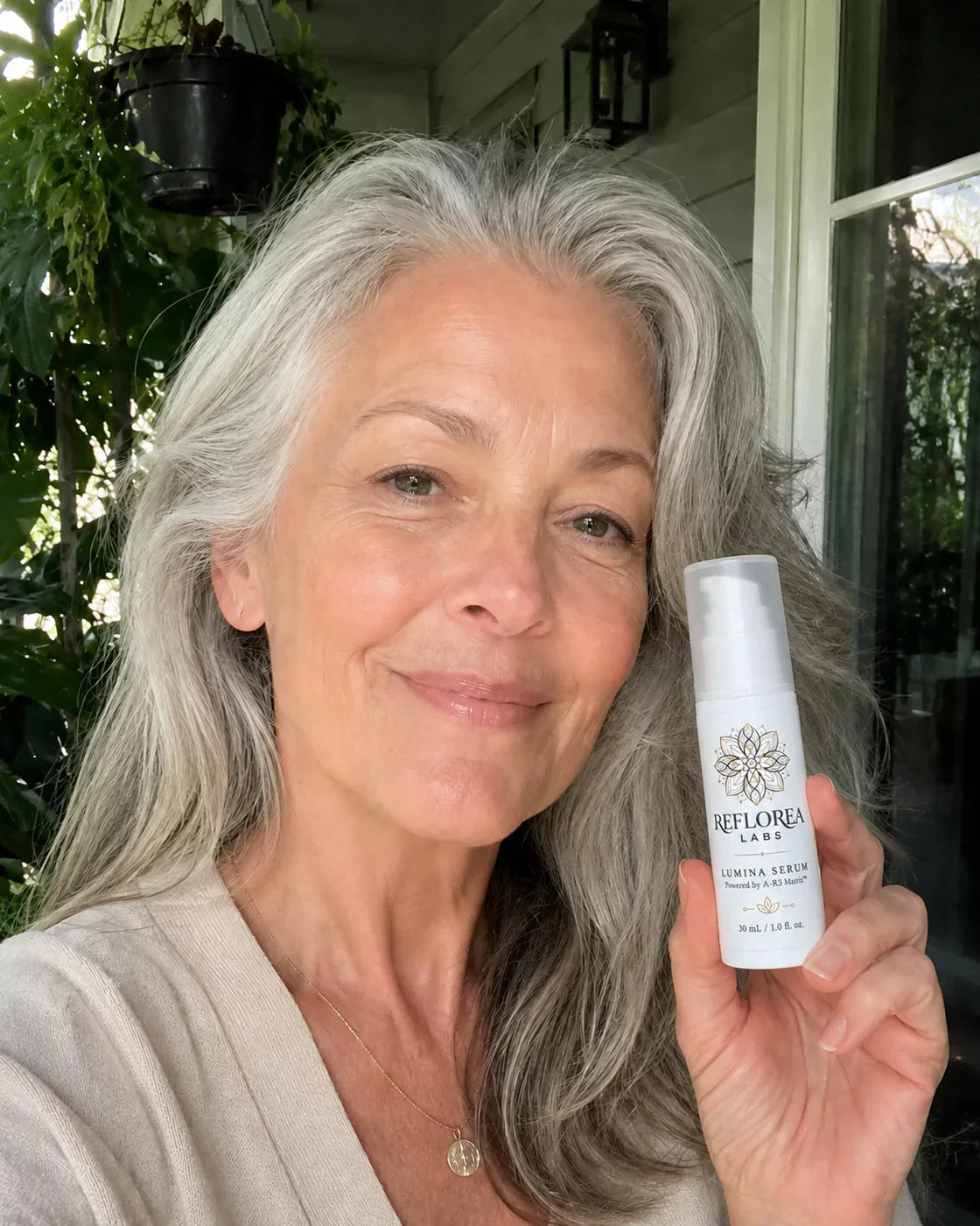 Woman holding the Lumina Serum bottle