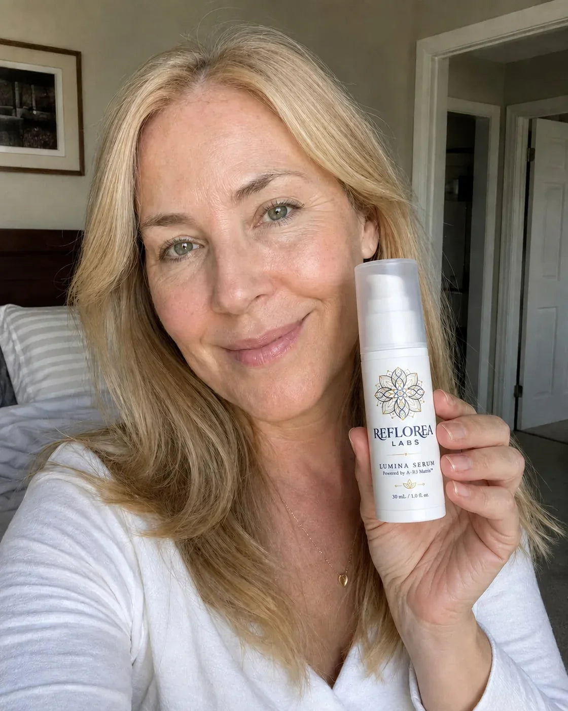 Woman holding the Lumina Serum bottle