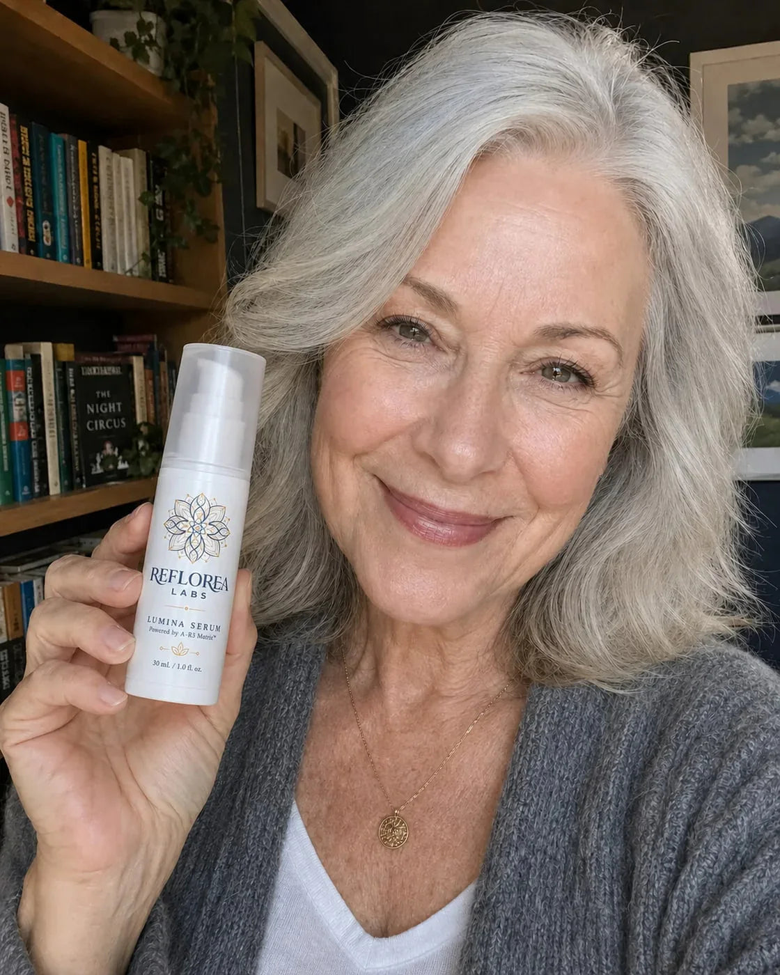 Woman holding the Lumina Serum bottle