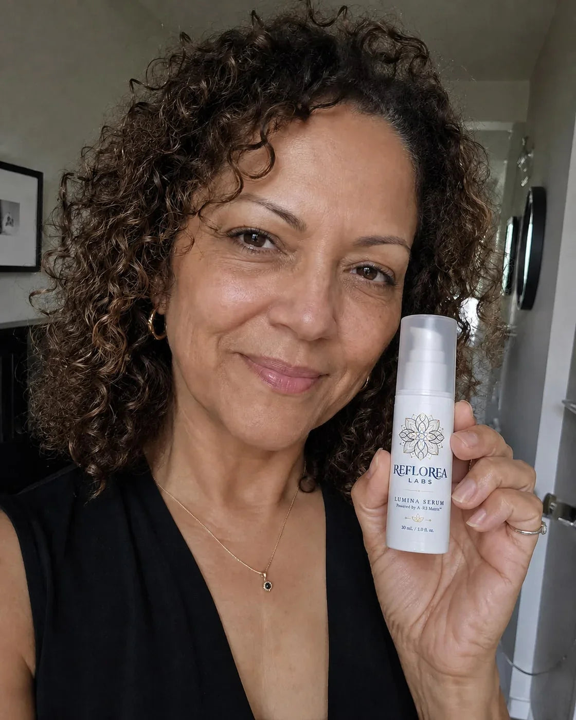 Woman holding the Lumina Serum bottle