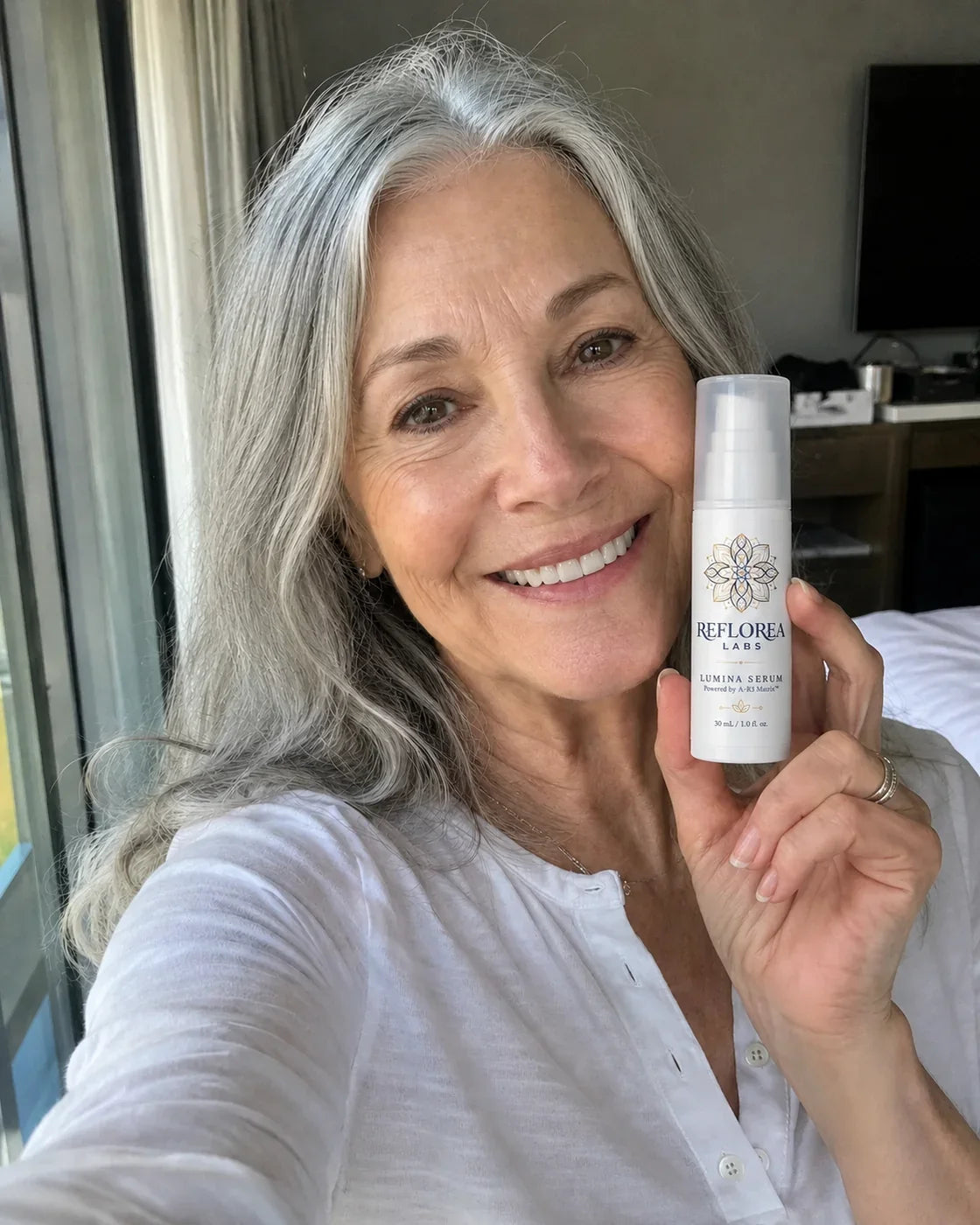Woman holding the Lumina Serum bottle